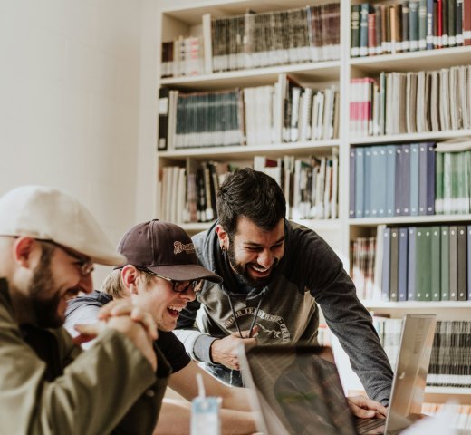 Hubit founders collaborating in a library